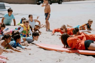 Learning to surf Lake Michigan begins with instruction on land before campers take to the water