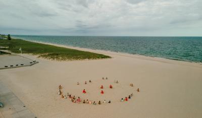 Every day at beach camp starts with circle time and stretching on the sand