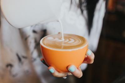 Barista pouring latte with latte art