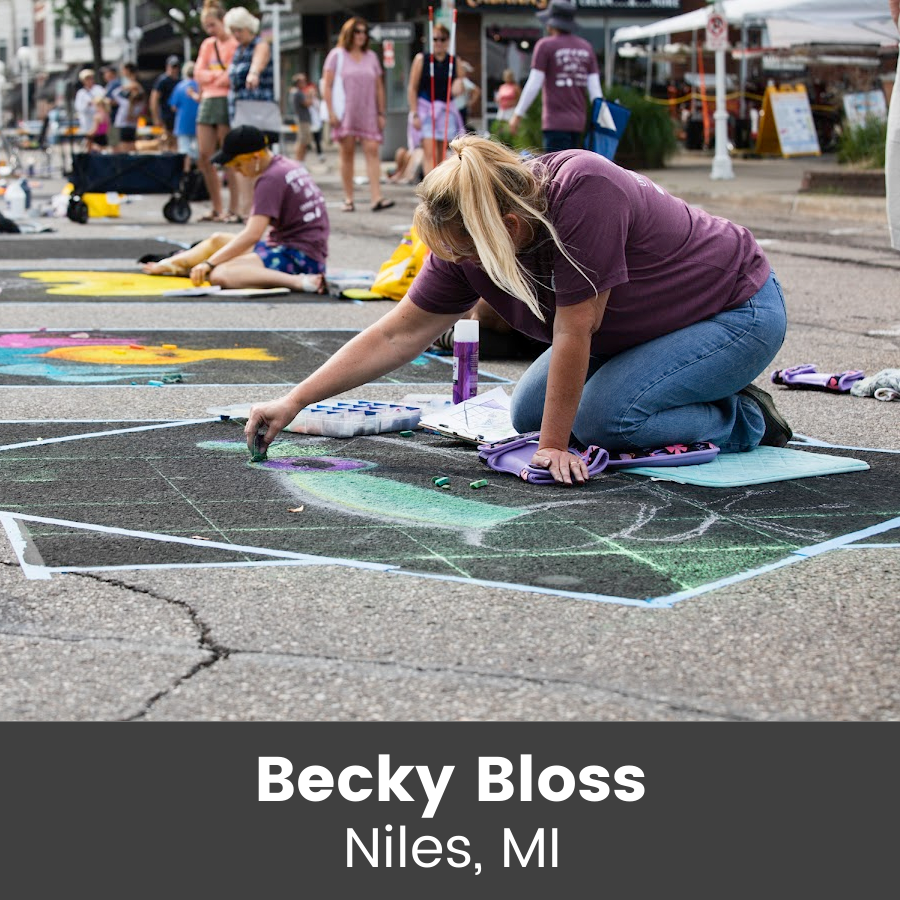 Artist working on chalk art piece
