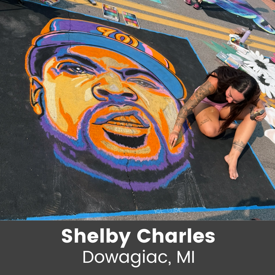 Artist working on large colorful portriat chalk art piece