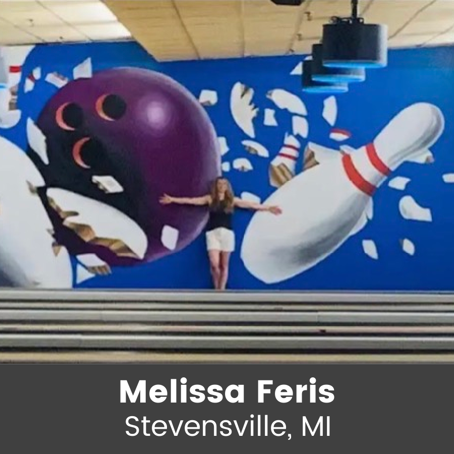 Artist standing in front of mural