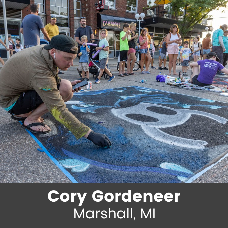Artist working on chalk art piece