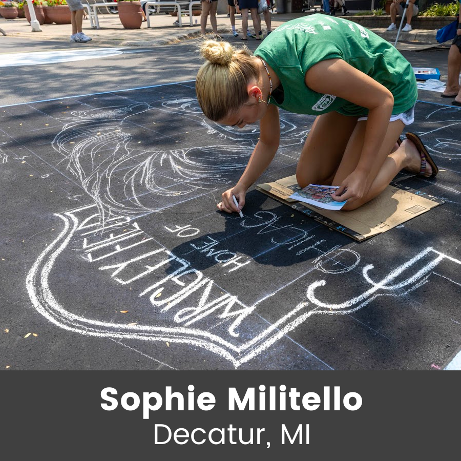 Artist working on chalk art piece