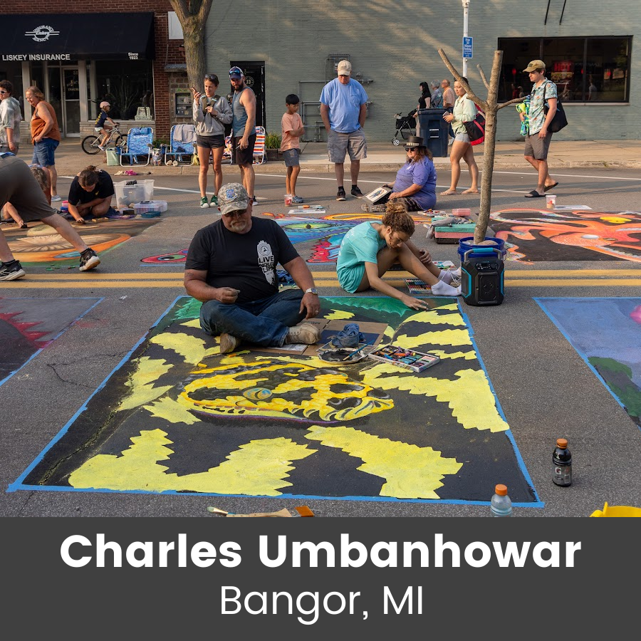 Artist working on chalk art piece