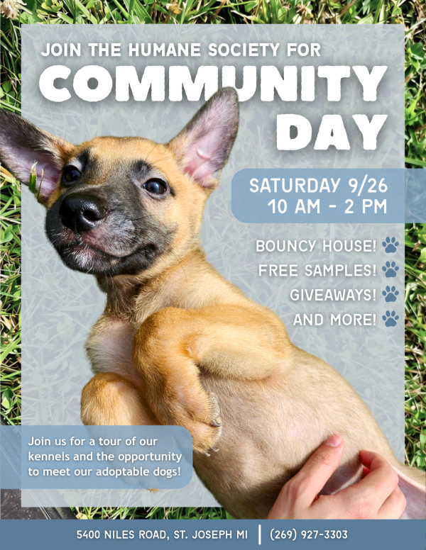 Flyer for Community Day with a picture of a puppy laying on its back.